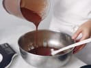 Cooking Class - Trio of Fall Bakes in Manhattan: Pouring maple custard mixture into ramekins from a mixing bowl.