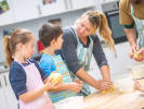 Cooking Class - Baking Brilliance - Teens' 5-Day Culinary Camp in South Bay & Peninsula: a woman chef is showcasing young teenagers how to make dough