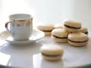 Cooking Class - Icons of French Baking in South Bay & Peninsula: Stack of vanilla macarons with a cup of espresso on a white saucer.