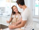 Cooking Class - Bold and Bavarian - Date Night in Northern Virginia: Couple preparing food together in a bright kitchen, smiling while chopping ingredients.