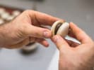 Cooking Class - Icons of French Baking in South Bay & Peninsula: Close-up of hands gently pressing two macaron halves together.