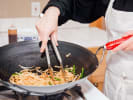 Cooking Class - Thai Flavor Night - Family Fun in Northern Virginia: stir-frying pad Thai in a wok