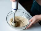 Cooking Class - Flavors of Coastal New England in Northern Virginia: A baker whisking a creamy batter in a glass mixing bowl