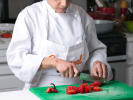 Cooking Class - Mexican Rendezvous - Date Night in Northern Virginia: A chef chopping fresh ingredients on a green cutting board in a kitchen
