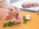Cooking Class - Britainâ€™s Favorite Bakes in Manhattan: A person preparing fresh rosemary
