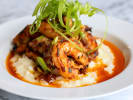 Cooking Class - A Taste of Southern Comfort: A plate of creamy grits topped with blackened chicken, scallions, and a rich, spicy sauce