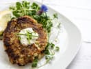 Cooking Class - New England Seafood Specialties in Northern Suburbs: A plate of crispy golden crab cakes with greens and a lemon wedge