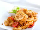 Cooking Class - Savoring Italian Culinary Traditions: A plate of golden fried calamari garnished with lemon slices and vegetables, served as an appetizer