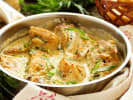 Cooking Class - Master the French Bistro in Northern Virginia: A plated dish with roasted chicken, vegetables, and sauce