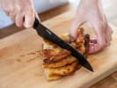 Team Building Cooking Class - Handmade Noodles and Dumplings in Hoboken: Chef cutting into stack of scallion pancakes