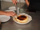 Team Building Cooking Class - Spanish Tapas With an Asian Twist: Chef plating Basque cheesecake with black sesame caramel during a Spanish tapas team building activity