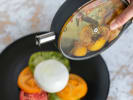 Cooking Class - Basics of Molecular Italian Gastronomy: Chef pouring olive oil onto Caprese salad