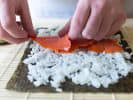 Cooking Class - Sushi Making Essentials in Newton: Chef rolling salmon sushi roll
