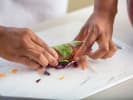 Cooking Class - African-American Cuisine Collision: Chef rolling spring rolls