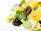 Cooking Class - Spanish Paella From Scratch: Citrus and olive salad plated with orange segments, black olives, and fresh greens