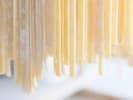 Cooking Class - Homemade Alfredo Pasta From Scratch: Close up of fettuccine pasta hanging to dry