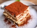 Cooking Class - Tastes of the Amalfi Coast in Minneapolis: Close up of tiramisu dusted with cocoa powder on a plate.
