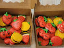 Team Building Cooking Class - Create Character Macarons With Your Team: Colorful fruit shaped character macarons arranged in takeaway boxes