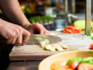 Team Building Cooking Class - Mystery Menu Challenge in Chicago: Fresh ingredients being chopped and prepared during a hands on team cooking challenge