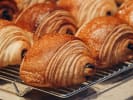 Cooking Class - Creative Croissant Selections in Manhattan: Freshly baked pain au chocolat with golden layers on a cooling rack