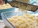 Cooking Class - Brioche Basics for Beginners in Manhattan: Freshly grated cheese being added to a baking dish of macaroni
