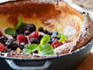 Cooking Class - A Brunch Worth Sharing in Boulder: Golden Dutch baby pancake topped with powdered sugar, fresh berries and mint