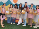 Cooking Class - Cute Character French Macarons in Culver City: Group of participants smiling and holding boxes of handmade character macarons after their baking class