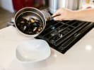 Cooking Class - Taste of the Italian Coast in Northern Virginia: Hand Holding Pot with Boiled Mussels