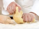 Cooking Class - Gourmet Fresh Pasta + Pasta Kit in Boulder: Hands kneading fresh pasta dough with a rolling pin on a floured surface