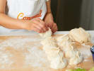 Cooking Class - Classic Dim Sum Favorites - Date Night in Dallas: Hands pleating dumpling dough on a flour-dusted counter