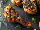 Cooking Class - Bold Caribbean Island Flavors - Date Night in Downtown Dallas: Jerk Chicken Thighs on a black stone plate with herb garnish