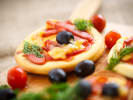 Kids' Cooking Class - Roll, Top and Bake Pizza: Mini pizzas topped with olives and veggies