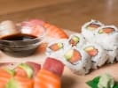 Cooking Class - The Secrets of Homemade Sushi: Nigiri and Sashimi plated next to philadelphia rolls and soy sauce