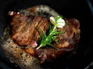 Cooking Class - Elegant Bistro Favorites - Date Night in Houston: Pan-roasted steak cooking in a skillet with pan jus