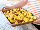 Cooking Class - Dairy and Gluten-Free French Bistro in Boston Proper: Person preparing herb roasted potatoes on a tray