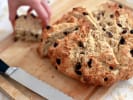 Online Cooking Class - St. Paddy's Day Feast: Person taking slice of Traditional Irish Soda Bread