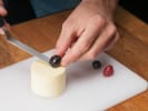 Cooking Class - Allergen-Free Mediterranean Feast in Boston: Person topping a finished panna cotta with berries