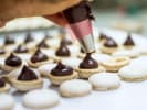 Cooking Class - Hazelnut Macarons 101 in Northern Virginia: Photo 4   piping filling into macaron shells