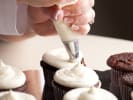 Cooking Class - Baking Bonanza - Family Fun in Downtown Dallas: Piping frosting on chocolate cupcakes