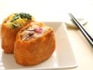 Cooking Class - A Journey Through Sushi: Plated inarizushi tofu pouches with chopsticks