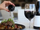 Cooking Class - Dinner en France - Date Night in Manhattan: Red wine being poured to accompany a gourmet steak dinner