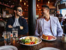 Food Tour - Discover Historic Chicago in Downtown Chicago: people enjoying deep dish pizza on a food tour