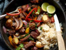 Cooking Class - Lomo Saltado & Peruvian Classics: Skillet of Peruvian lomo saltado with seared steak, red onion, and tomatoes served alongside rice