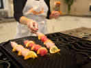 Private Chef - Mediterranean Poolside Menu: a chef preparing chicken kebab bbq