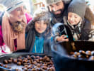 Food Tour - Holiday Bites and Market Delights in D.C.: a family enjoying roasted chestnuts on a food tour