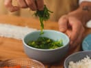 Cooking Class - Essential Sushi Skills - Date Night in Charlotte: a man picking seaweed for making sushi