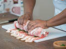 Cooking Class - Spanish Flavors to Savor in Manhattan: a person is slicing meat on a cutting board