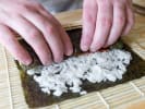 Cooking Class - Sushi Maki Mania in Northern Virginia: a person making maki sushi rolls