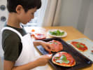 Cooking Class - 4-Day Foodie Fun Kids: Busy Bakers Cooking Camp in Downtown Dallas: a child making individual pizzas