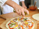 Cooking Class - Pizza Night Like a Pro in Vancouver: adding a drizzle of oil on top of vegetarian pizza